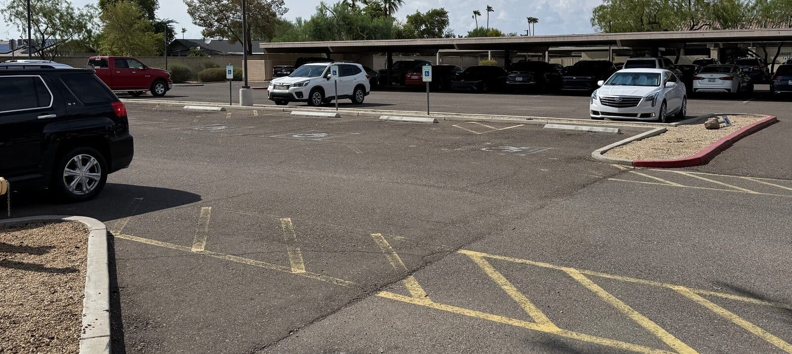Surface parking lot at the Peoria Medical & Professional Center, with covered parking and marked accessible spaces near the building entrance